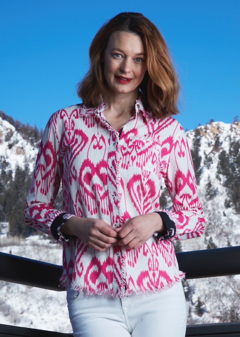 Pink and white Ikat print Cape Cod Tunic by Dizzy-Lizzie, featuring a relaxed fit and stylish design, displayed on a hanger.