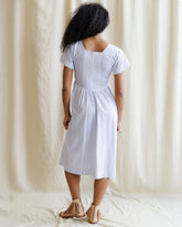 Downeast countryside dress with floral print, flowing fabric, and short sleeves, displayed on a hanger.