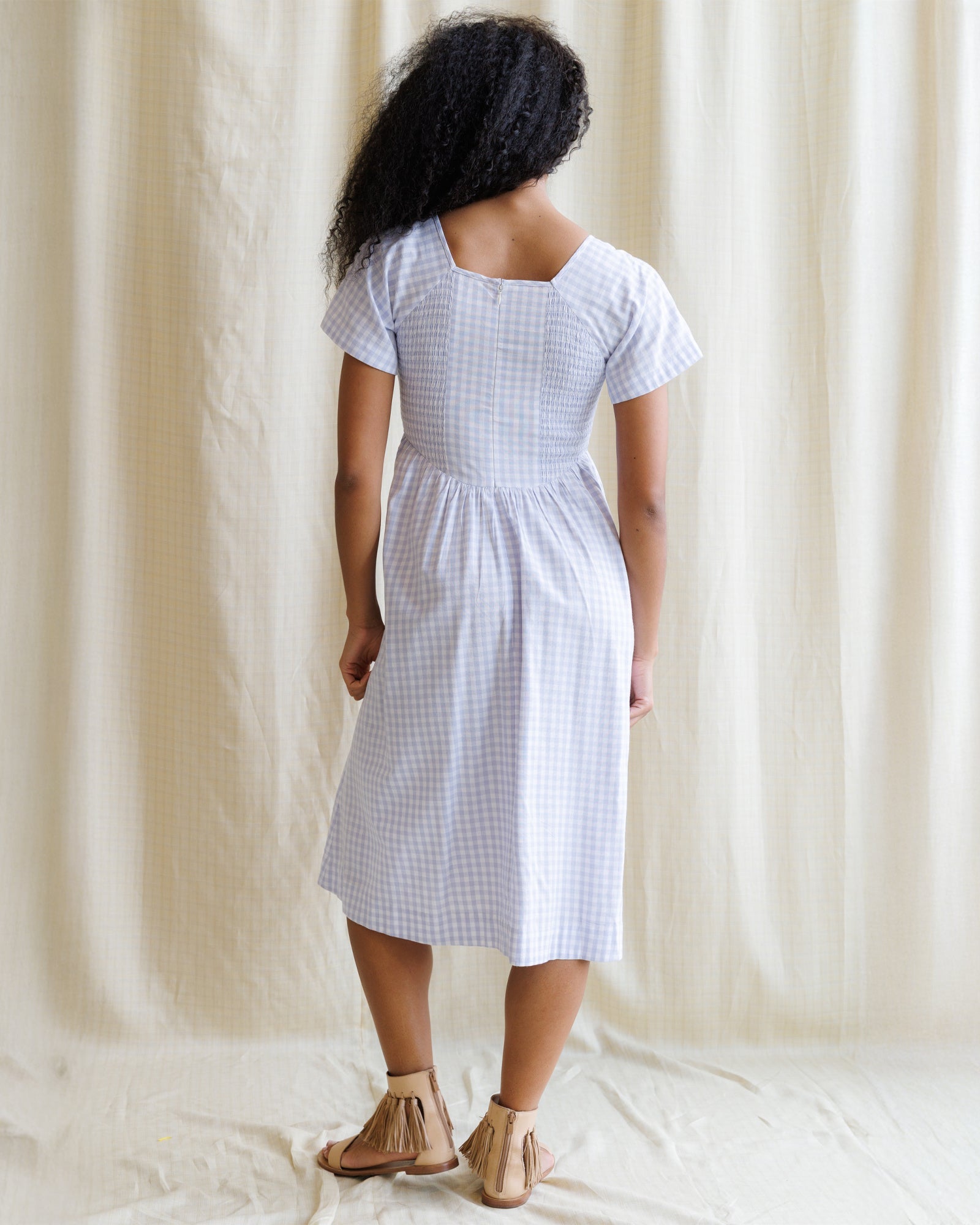 Downeast countryside dress with floral print, flowing fabric, and short sleeves, displayed on a hanger.