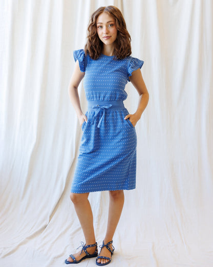 Downeast On Repeat Dress displayed on a hanger with floral pattern and flowing fabric, perfect for casual or summer wear.