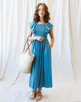 Downeast Sol Mate Dress shown hanging with floral pattern and flowing fabric, perfect for casual summer wear.