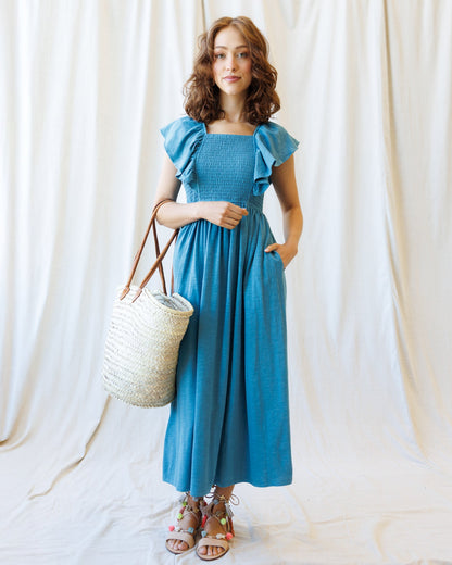 Downeast Sol Mate Dress shown hanging with floral pattern and flowing fabric, perfect for casual summer wear.