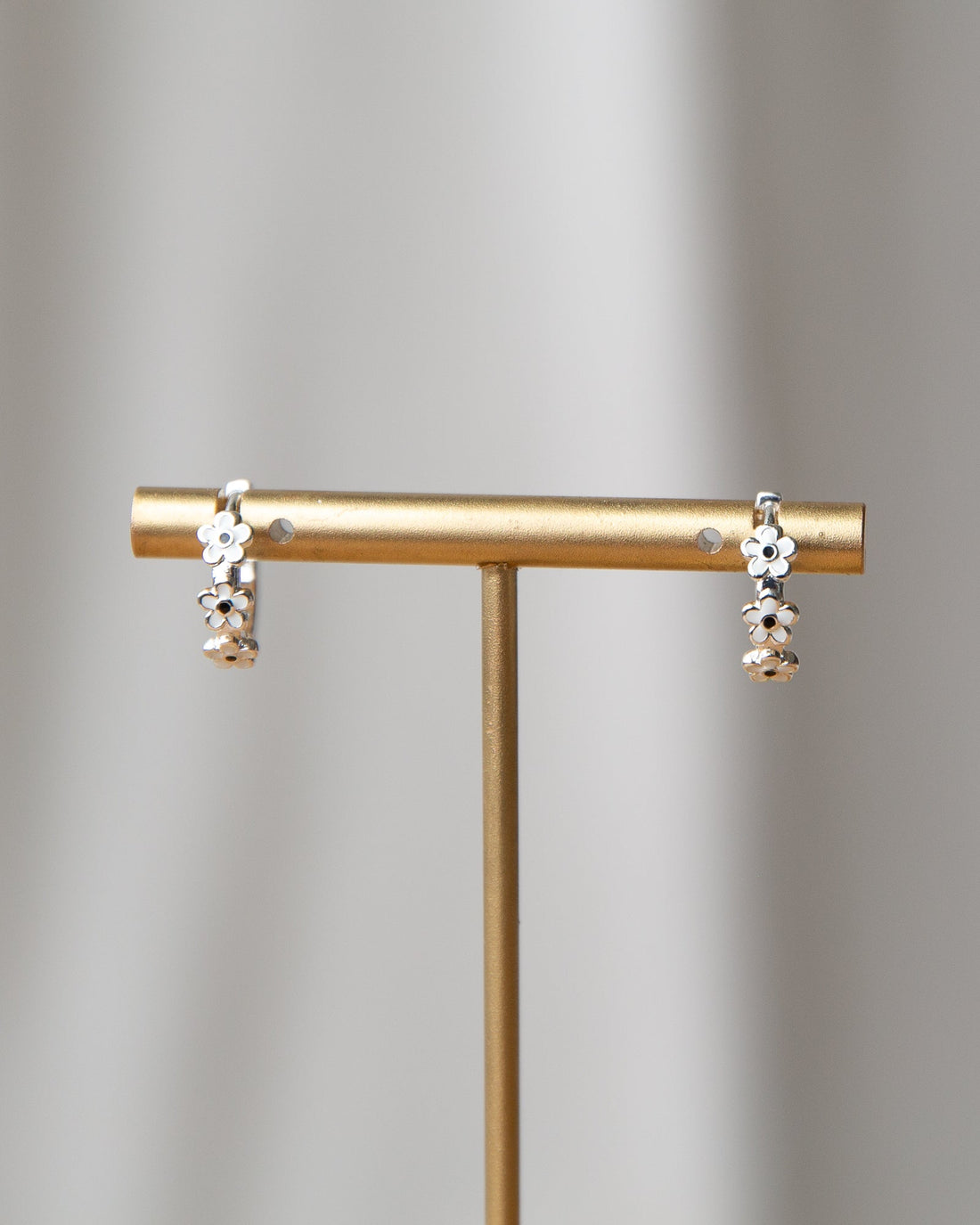 Silver In Bloom Huggie Hoop earrings by Downeast, featuring delicate floral design and a polished silver finish.
