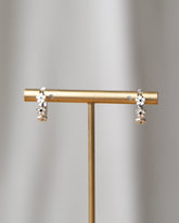 Silver In Bloom Huggie Hoop earrings by Downeast, featuring delicate floral design and a polished silver finish.