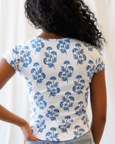 Downeast Artistic Tee, a stylish casual top with artistic design, displayed on a hanger against a neutral background.