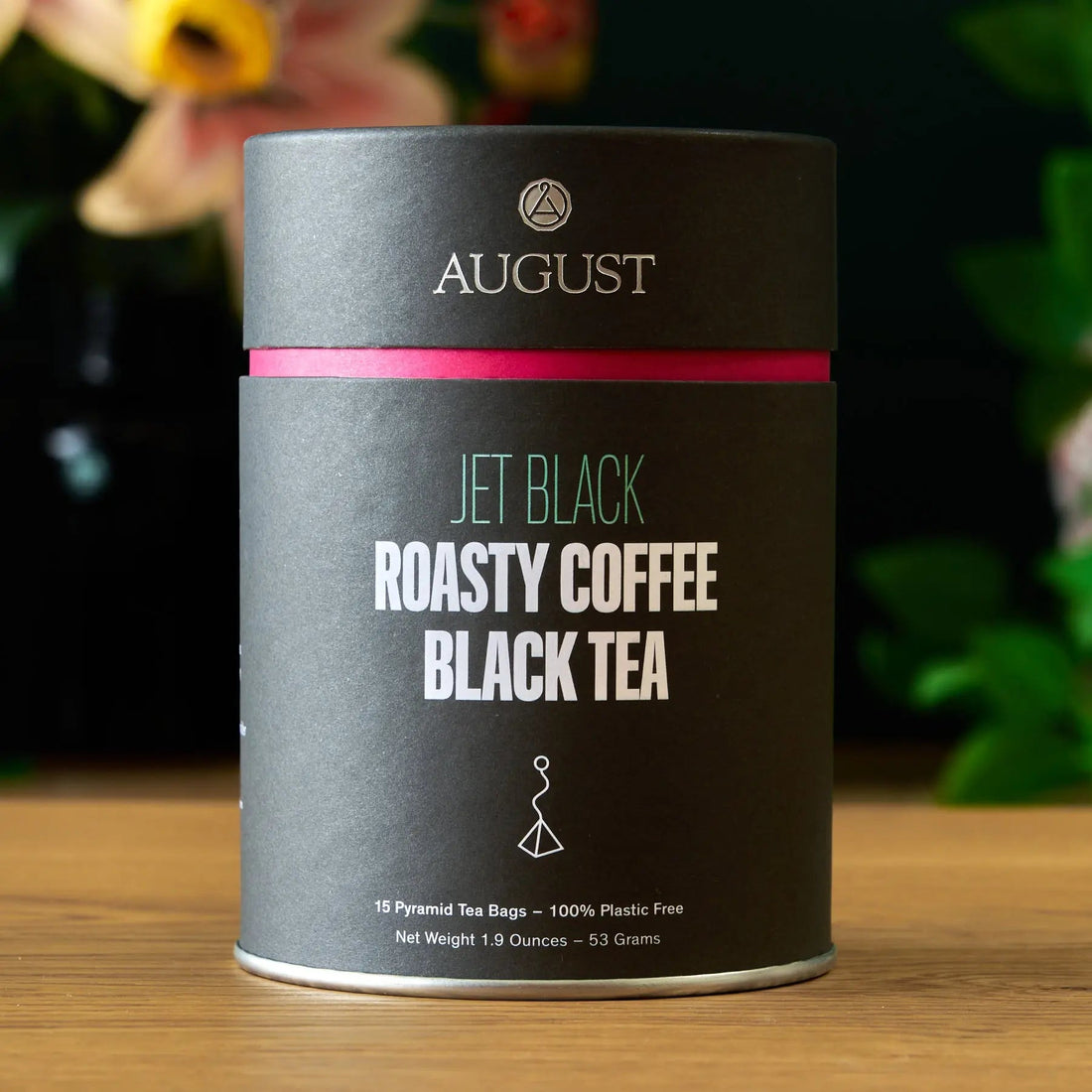 Jet Black Roasty Coffee Black Tea by August Uncommon Tea, 15 tea bags in a box, featuring dark black tea leaves.