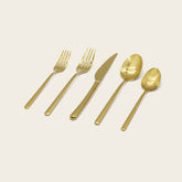 Italic Emilia Mirror 20-piece flatware set with polished stainless steel forks, knives, and spoons arranged on a neutral background.