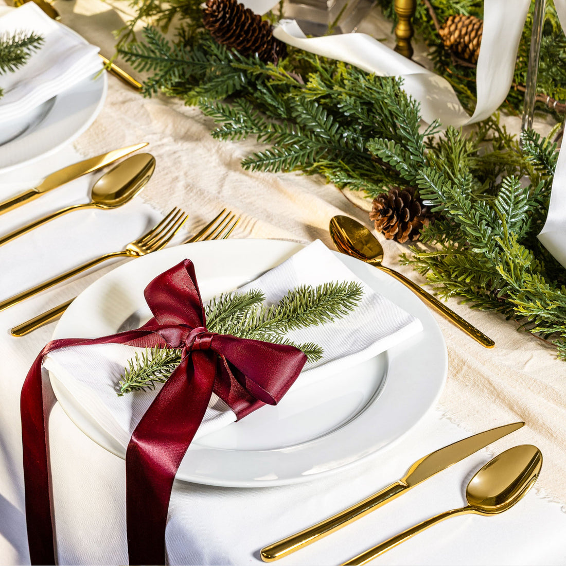 Italic Emilia 20-piece gold flatware set including forks, knives, spoons, and teaspoons arranged on a table.