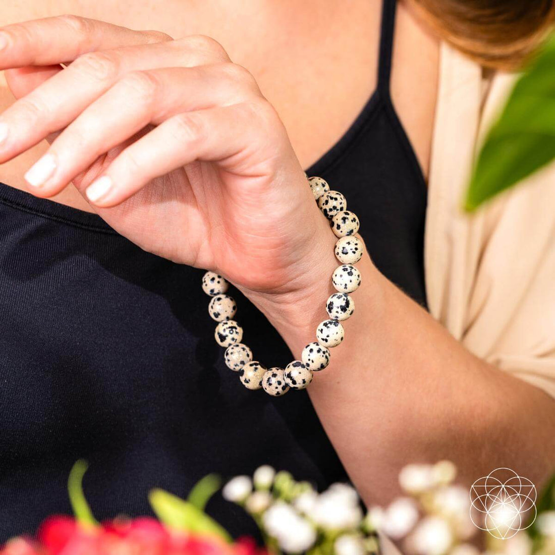 Dalmatian Jasper bracelet from Conscious Items featuring a string of polished black and white spotted gemstone beads.