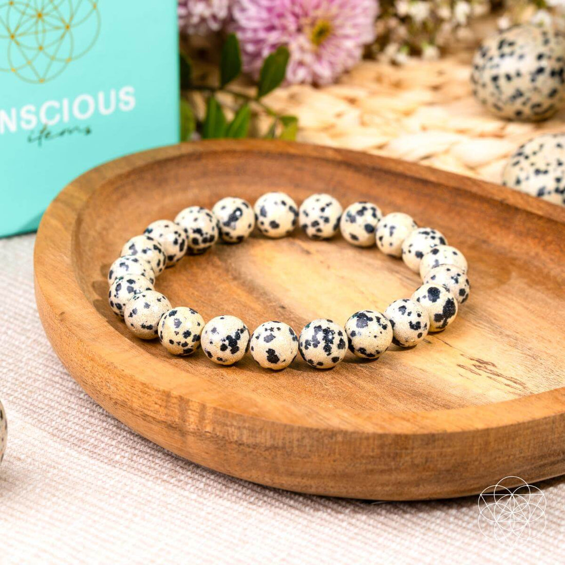 Dalmatian Jasper bracelet from Conscious Items featuring round beads with black spots, perfect for emotional detox and healing.