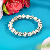 Dalmatian Jasper bracelet from Conscious Items featuring a string of spotted stone beads for emotional detox and healing.
