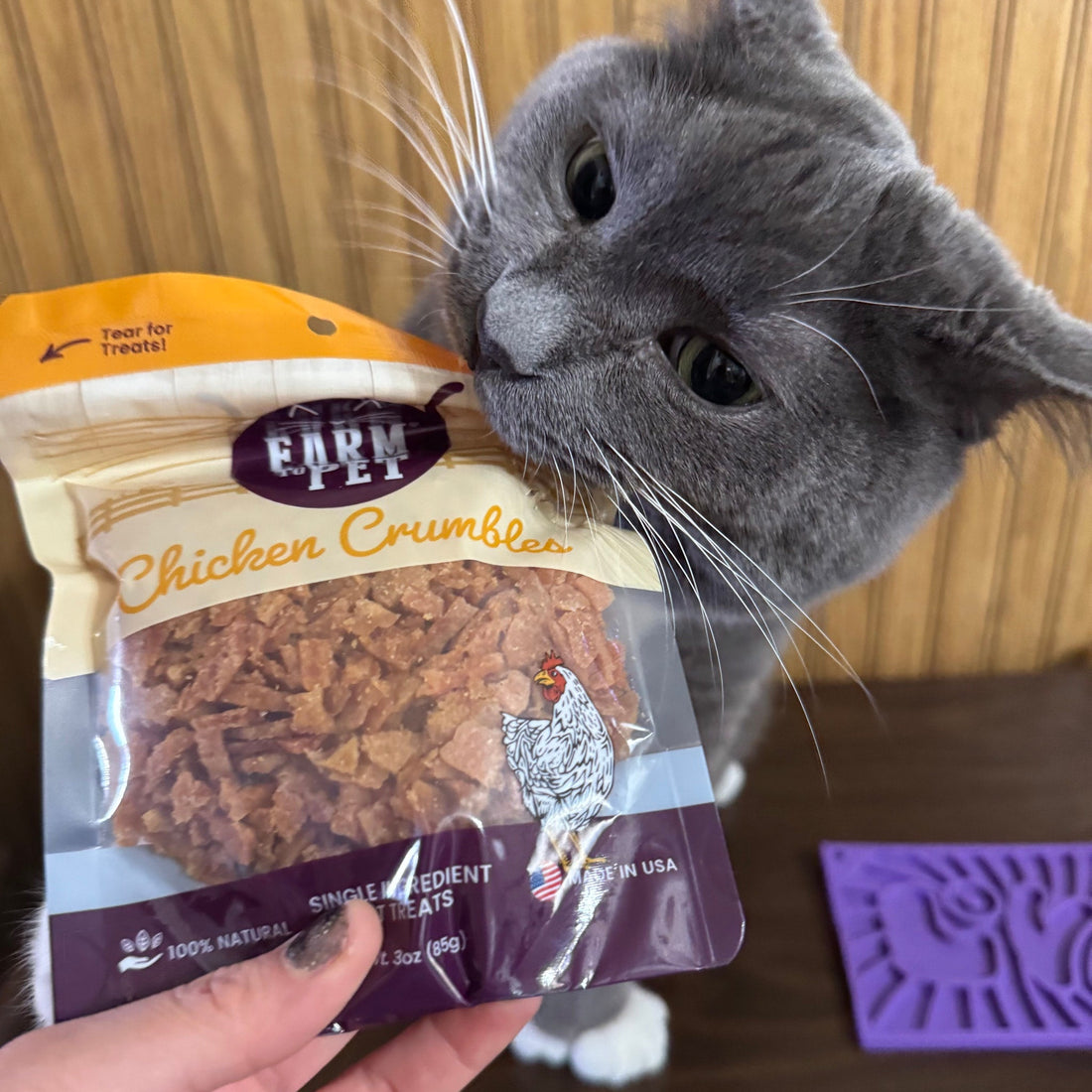 Farm To Pet chicken crumble cat treats in front of packaging, showcasing single-ingredient, USA-made cat snacks for healthy feline treats.