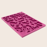 Maroon Farm To Pet Lick Mat for cats and small dogs, fishbone design, rectangle shape, side view.