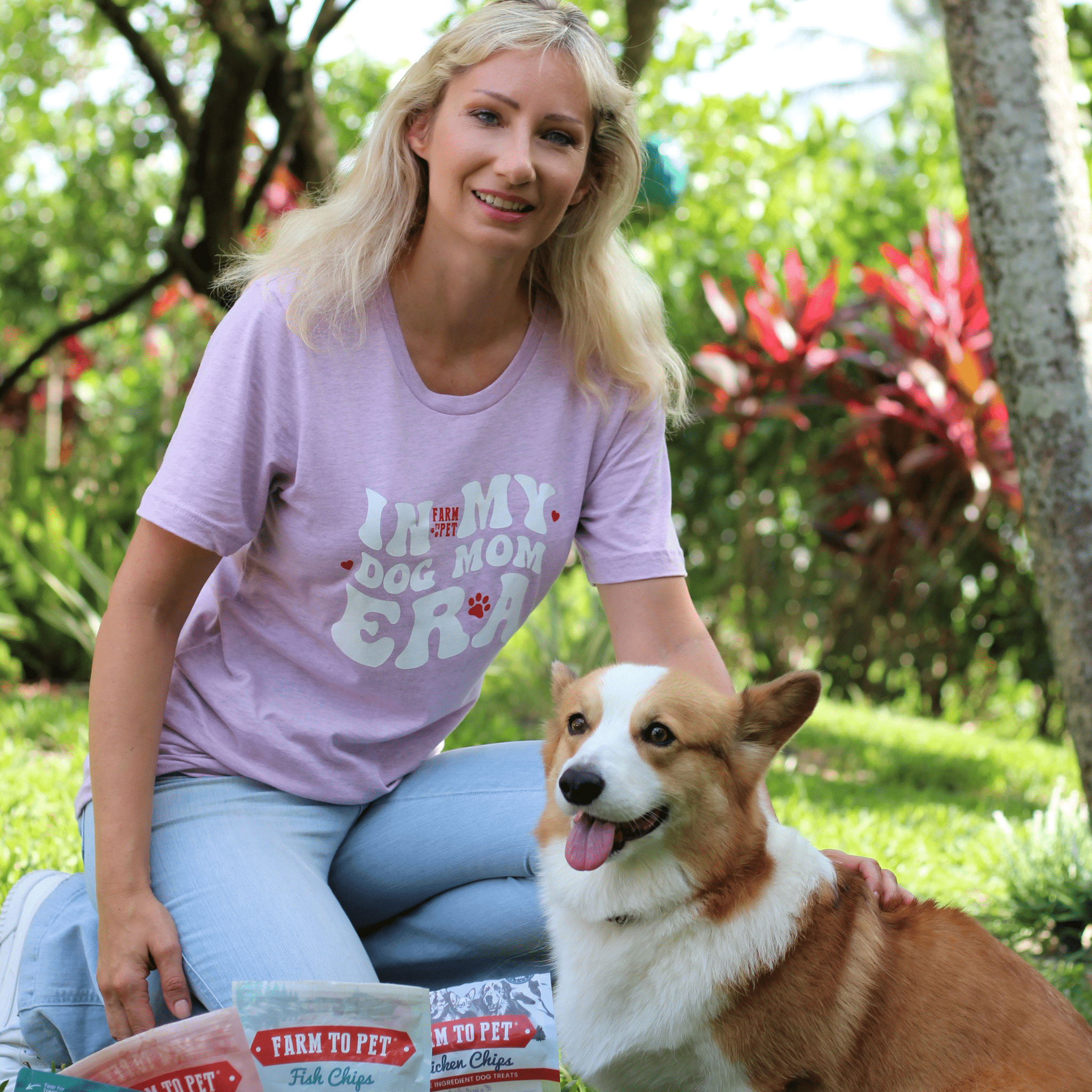 Purple Farm To Pet Dog Mom Era T-shirt with paw print design, perfect for dog moms, shown outdoors.