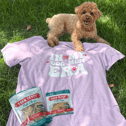 Purple "Dog Mom Era" T-shirt by Farm To Pet featuring dog paw prints, perfect for dog moms and pet lovers.