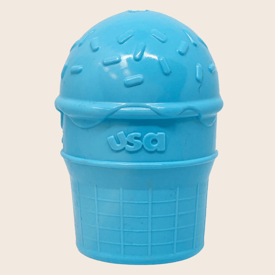 Close-up of Farm To Pet treat dispenser for dogs in blue ice cream color, showing the dispenser with dog treats inside.