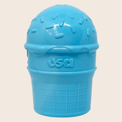 Close-up of Farm To Pet treat dispenser for dogs in blue ice cream color, showing the dispenser with dog treats inside.