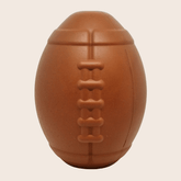 Farm To Pet dog treat dispenser in brown with football shape, close-up view showing the textured surface and dispensing opening.