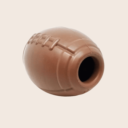 Farm To Pet dog treat dispenser in brown, football-shaped design, shown from a side view, for interactive pet feeding.