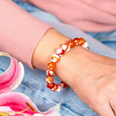 Feminine Force Carnelian Orca Agate bracelet by Conscious Items featuring polished orange and black patterned stone beads