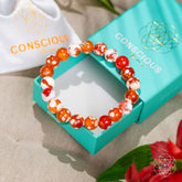 Feminine Force Carnelian Orca Agate bracelet by Conscious Items featuring vibrant orange agate beads and intricate design.
