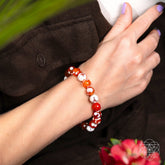 Feminine Force Carnelian Orca Agate bracelet by Conscious Items featuring orange carnelian and black and white orca agate beads.