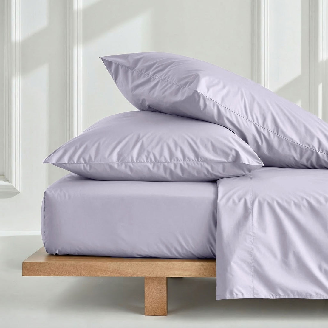 Elegant Luxe Australian Sateen Pillowcase Set by Italic featuring smooth, shiny satin fabric on a neatly made bed.