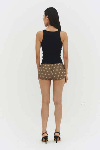Black ribbed knit tank top from findmenowthelabel, close-up of the textured knit fabric and sleeveless design.