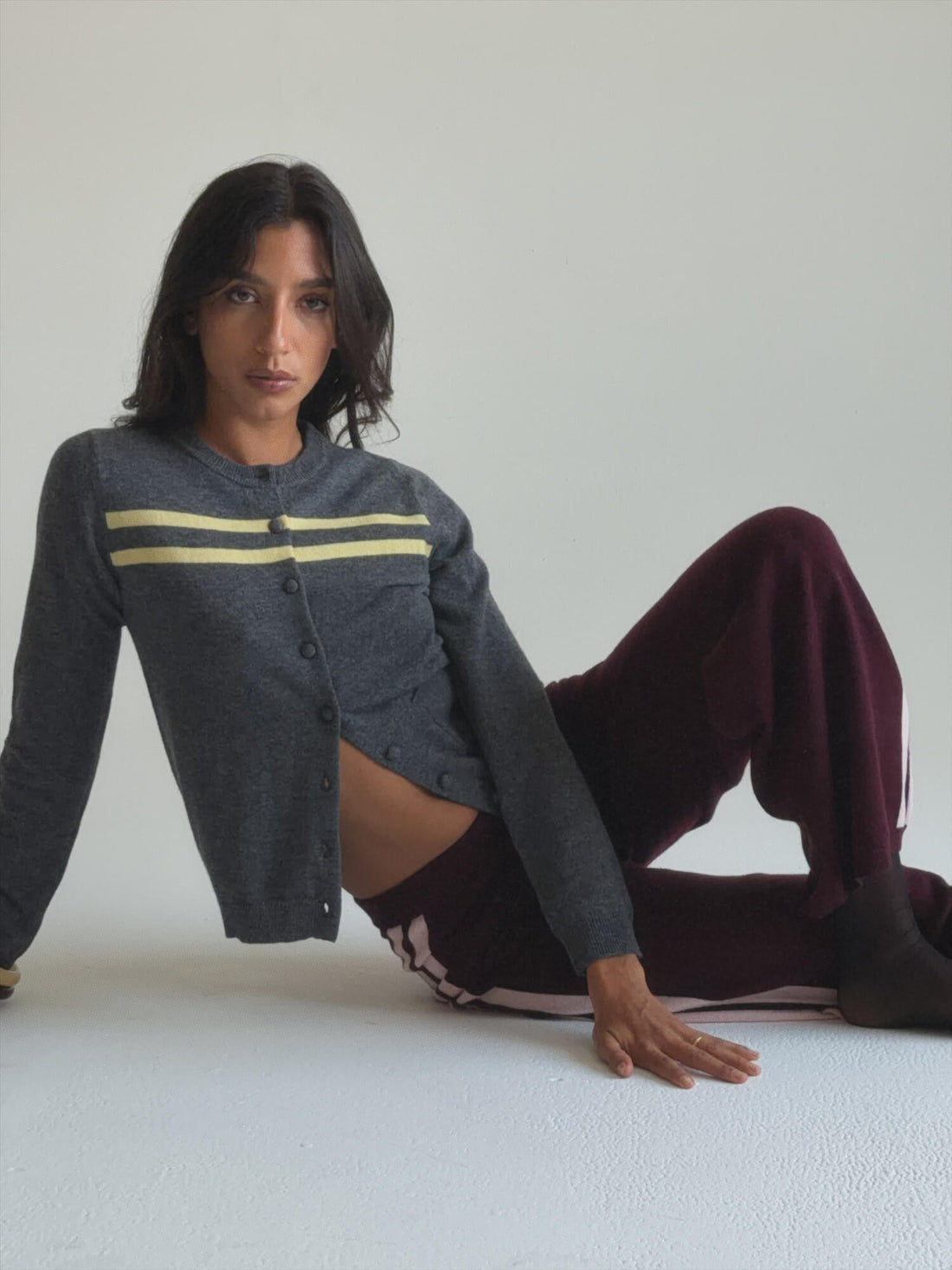 Charcoal and butter striped cashmere wool cardigan by findmenowthelabel, showcasing its cozy knitwear design and color pattern.