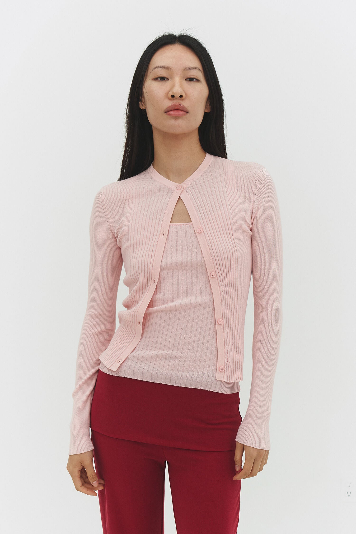 Powder pink ribbed knit cardigan from findmenowthelabel, showcasing a cozy, textured knitwear design with a button-up front.