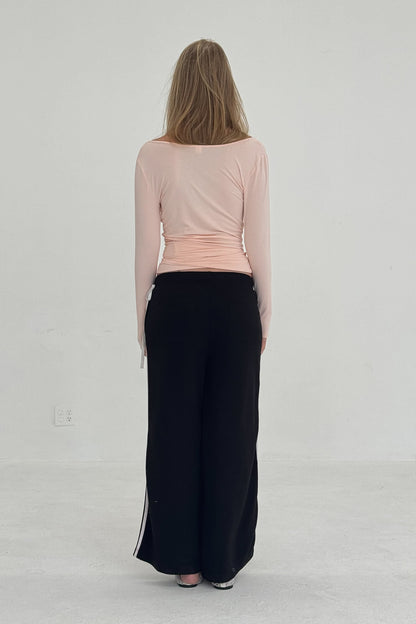 Black French Terry Bow Jogger pants by findmenowthelabel with a relaxed fit and elastic waistband, shown on a model.