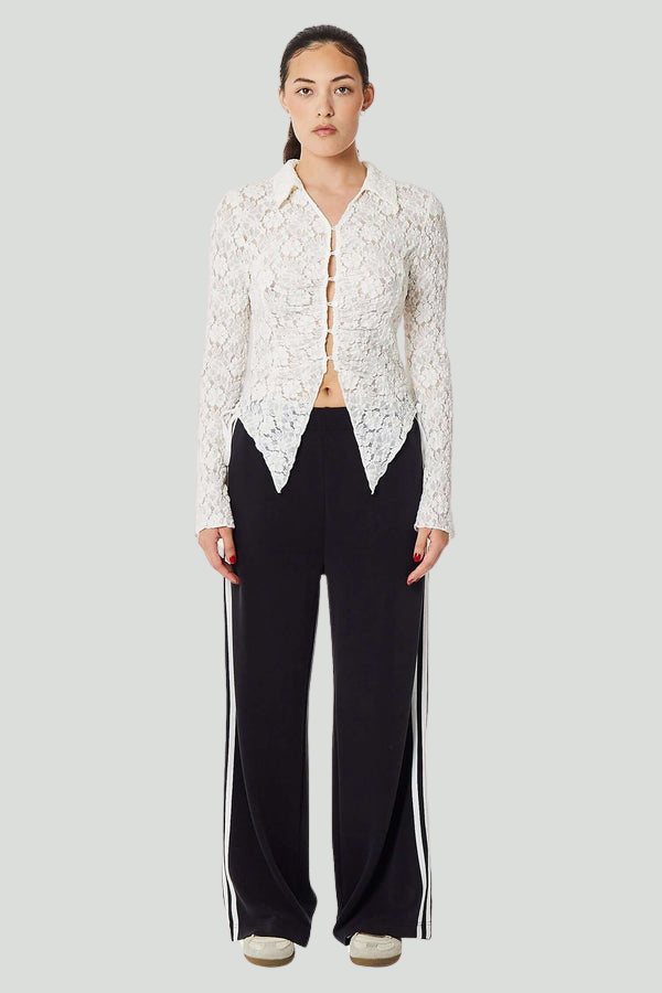 Black French Terry Bow Jogger pants by findmenowthelabel, showing a relaxed fit with elastic waistband and tapered cuffs.