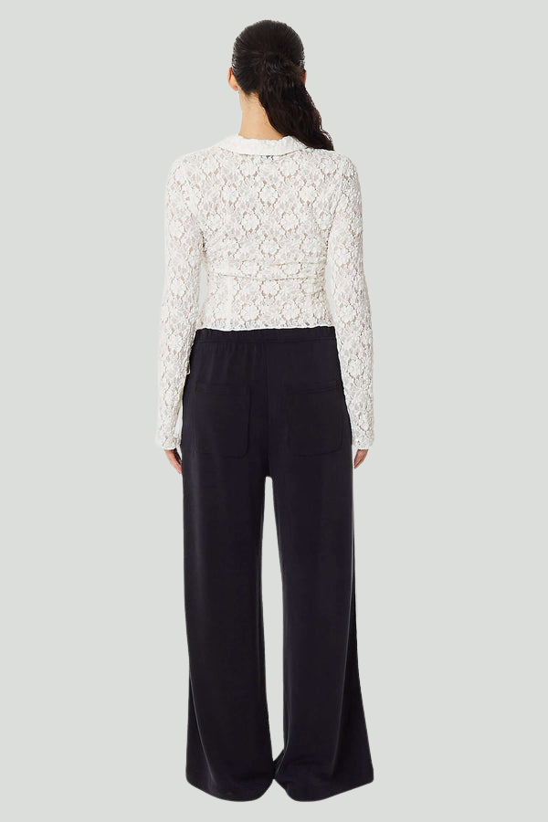 Black French Terry Bow Jogger pants by findmenowthelabel, featuring a relaxed fit and drawstring waistband.