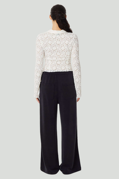 Black French Terry Bow Jogger pants by findmenowthelabel, featuring a relaxed fit and drawstring waistband.