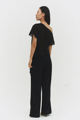 Black BRISA top by findmenowthelabel featuring a fitted design and soft fabric, shown on a model in a casual setting.