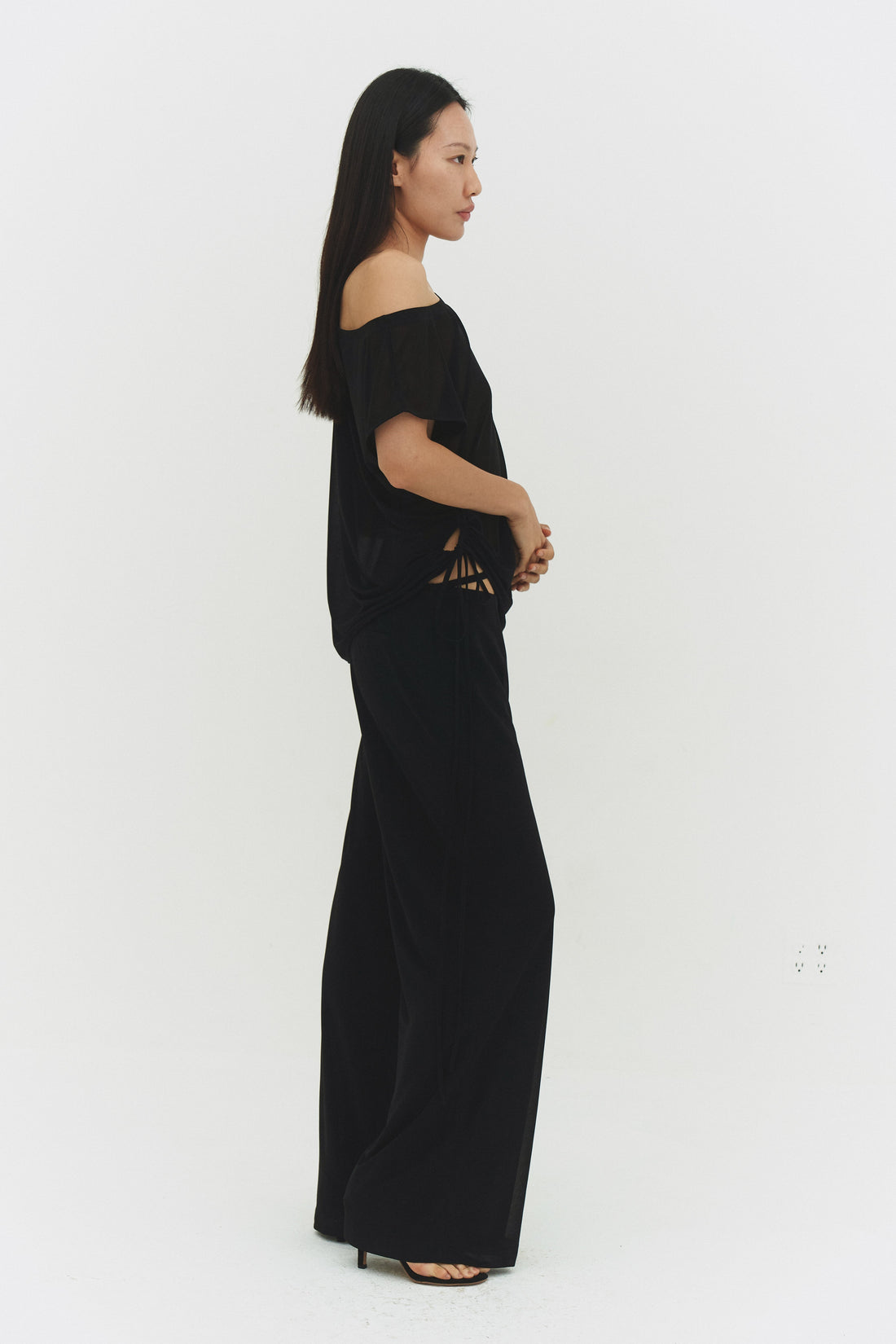 Black findmenowthelabel Brisa top shown on a model, featuring a stylish, fitted design with a high neckline and sleek fabric.