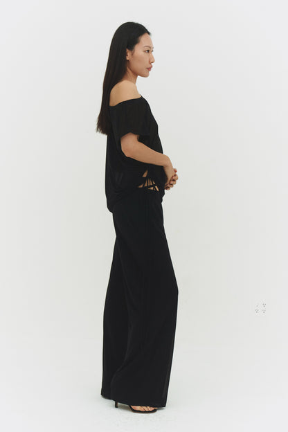 Black findmenowthelabel Brisa top shown on a model, featuring a stylish, fitted design with a high neckline and sleek fabric.