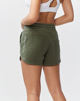 Goal Five Freasy Short in dark moss color, lifestyle shot showing comfortable fit and casual style on model.