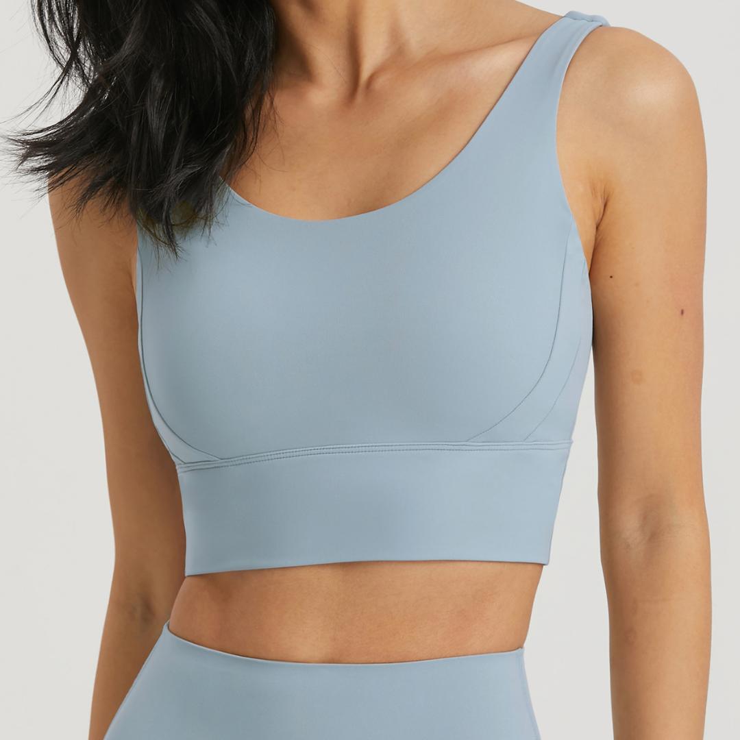 BLACKOUT BARBELL Omni Bra in Cloudy Blue, showing a close-up of the seamless, supportive sports bra on a model.
