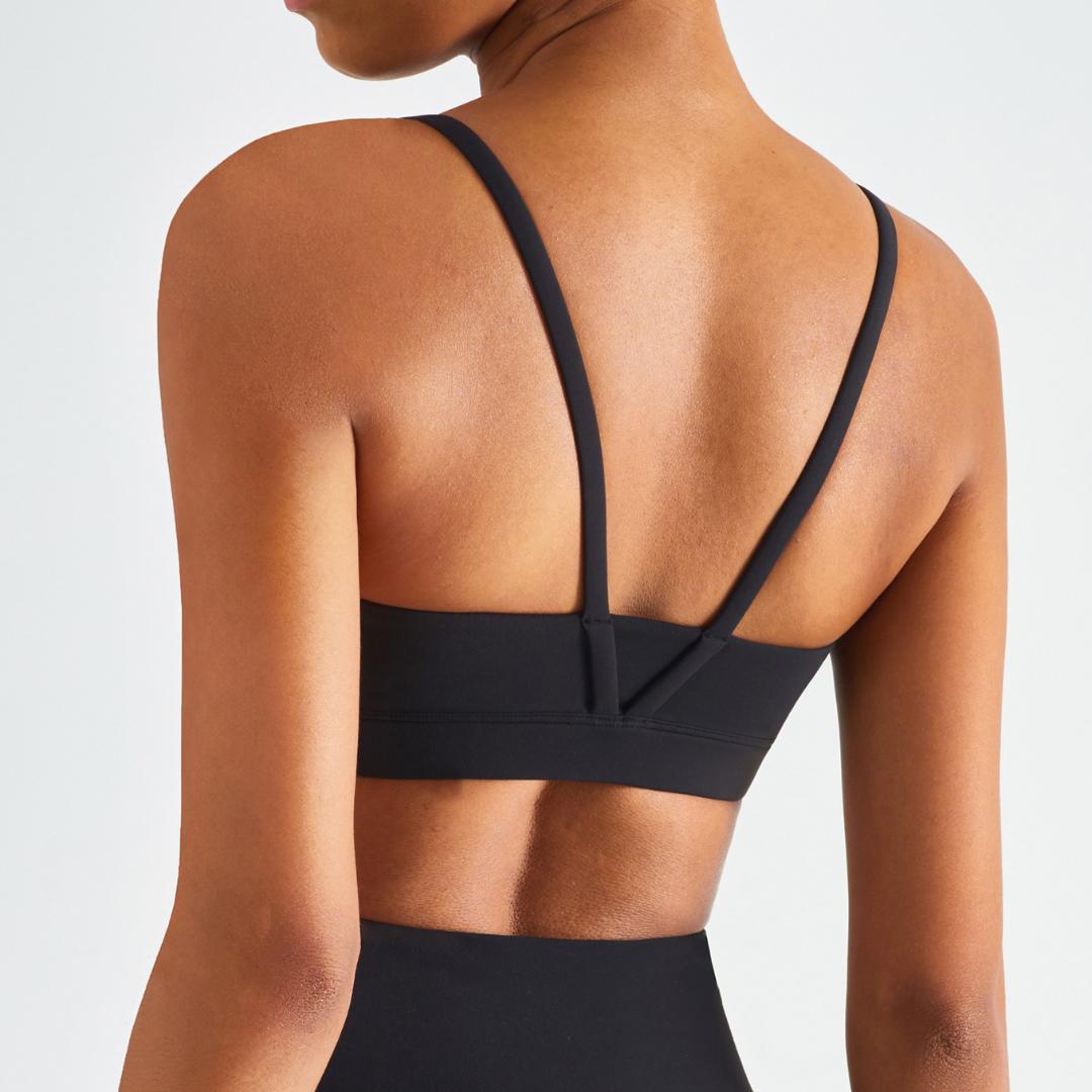 Black blackout barbells Echo Bra in black, showcasing its comfortable fit and sleek design for active wear.