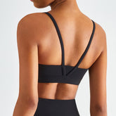 Black blackout barbells Echo Bra in black, showcasing its comfortable fit and sleek design for active wear.