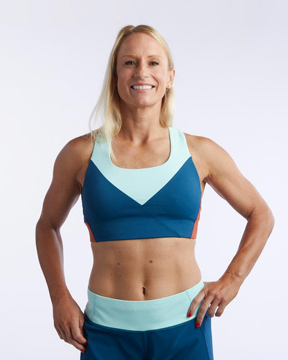 Dark teal and cinnabar Pionxr training bra top by Goal Five, shown from the front with supportive straps and sleek design.