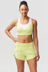 White Pionxr training bra top by Goal Five, featuring a sleek design with light blue and sky blue accents, suitable for active wear.