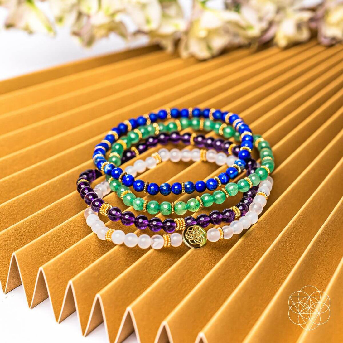 Set of four Good Karma jewelry bracelets by Conscious Items featuring symbols of luck and success on colorful beaded designs.