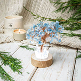 Aquamarine Tree Guardian Angel Night Light by Conscious Items featuring a protective angel figure and a shimmering aquamarine-colored tree.
