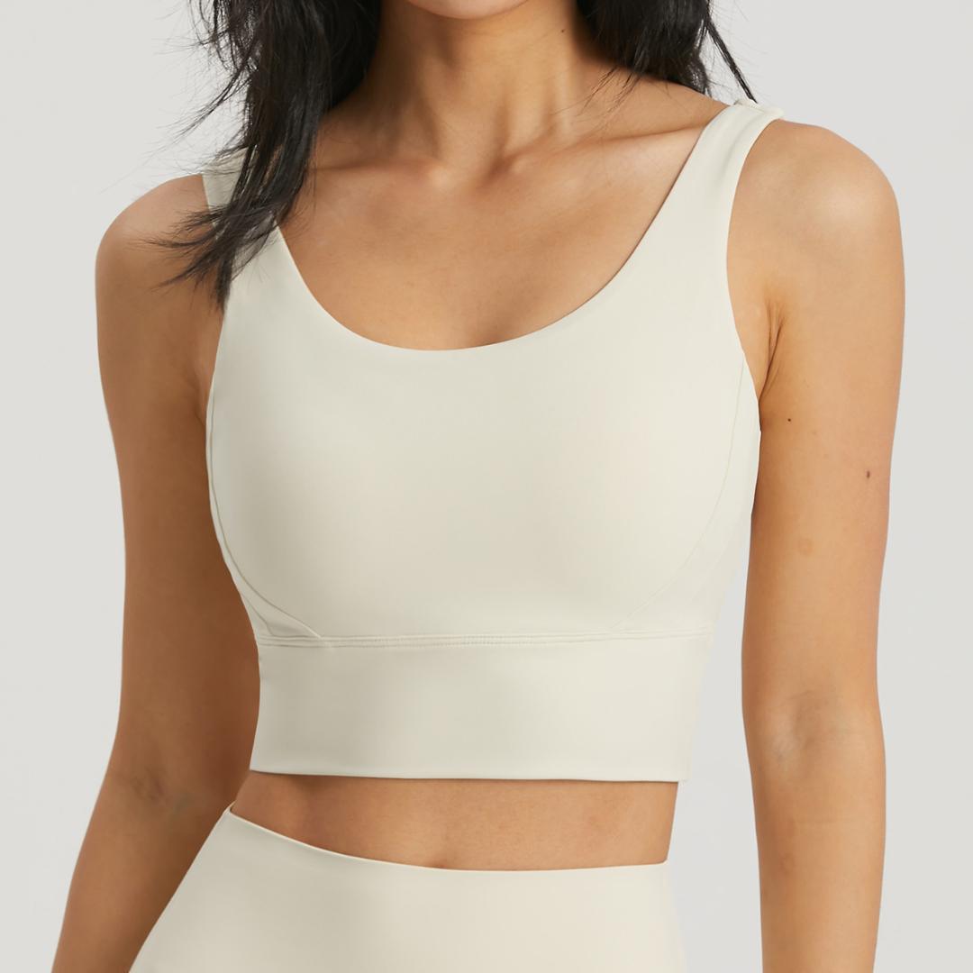 Off-white BLACKOUT BARBELL Omni Bra with supportive design and adjustable straps, shown on a mannequin.