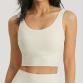 Off-white BLACKOUT BARBELL Omni Bra with supportive design and adjustable straps, shown on a mannequin.