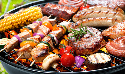 Igotchu BBQ Seasoning jar with spicy, flavorful blend shown next to grilled meats and vegetables on a barbecue grill.