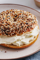 Igotchu Seasonings everything bagel seasoning in a jar, with visible sesame, poppy seeds, and dried garlic and onion bits.