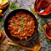 Igotchu Chili Seasoning in a jar with red chili peppers and spices, perfect for adding heat and flavor to dishes.